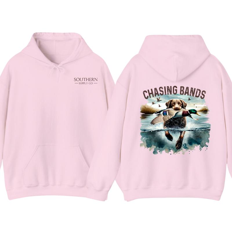 Chasing Bands Duck Hunting Hoodie - Chocolate Lab Retriever with Mallard Duck Waterfowl Graphic for Outdoor Enthusiasts, Unisex