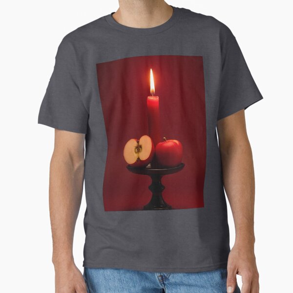 Burning candle with red apple on rustic board Classic T-Shirt